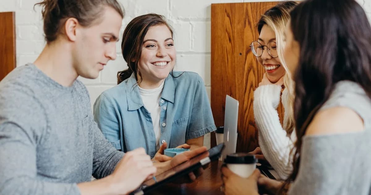 Group of friends gathered around a table at a social event