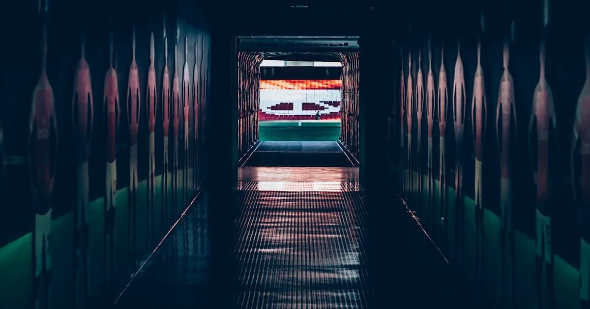 Stadium tunnel opening onto a football field, the walk toward the playoffs